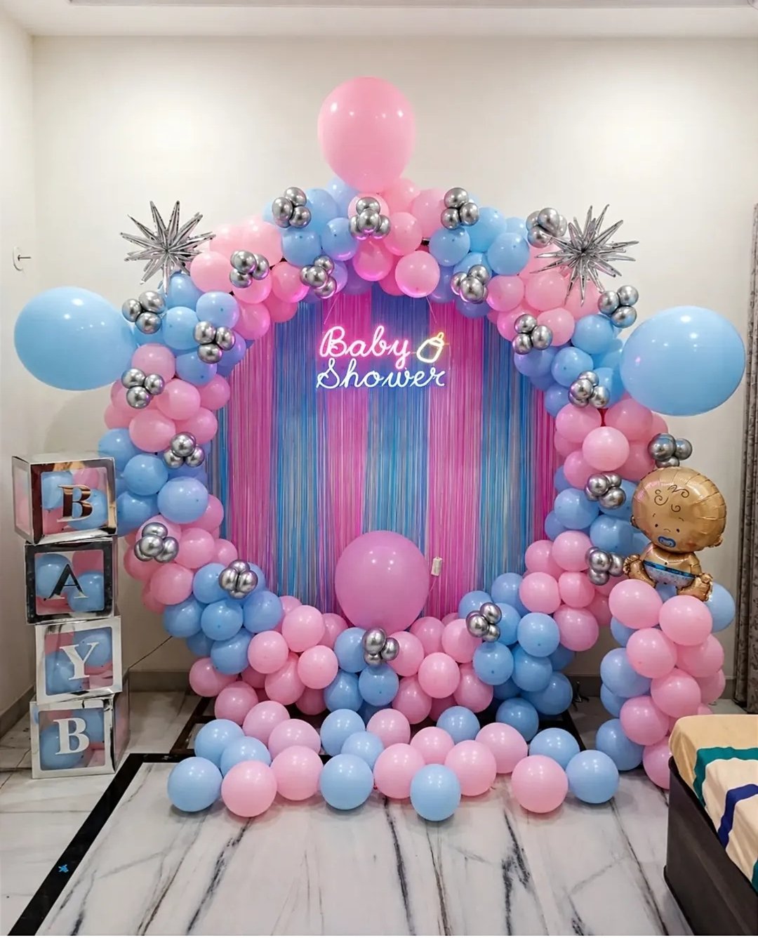 Pink and blue baby shower balloon ring with neon sign
