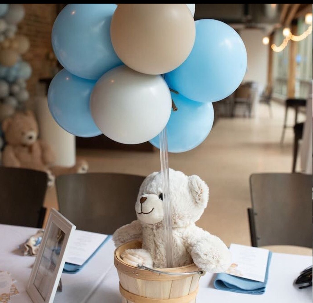 Blue and cream balloon centrepiece with a teddy bear