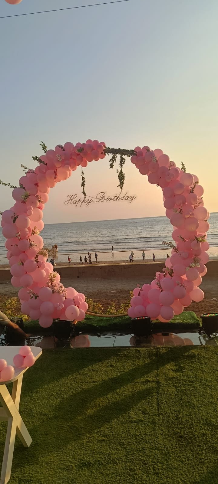 Pink balloon ring on a Mumbai beach at sunset