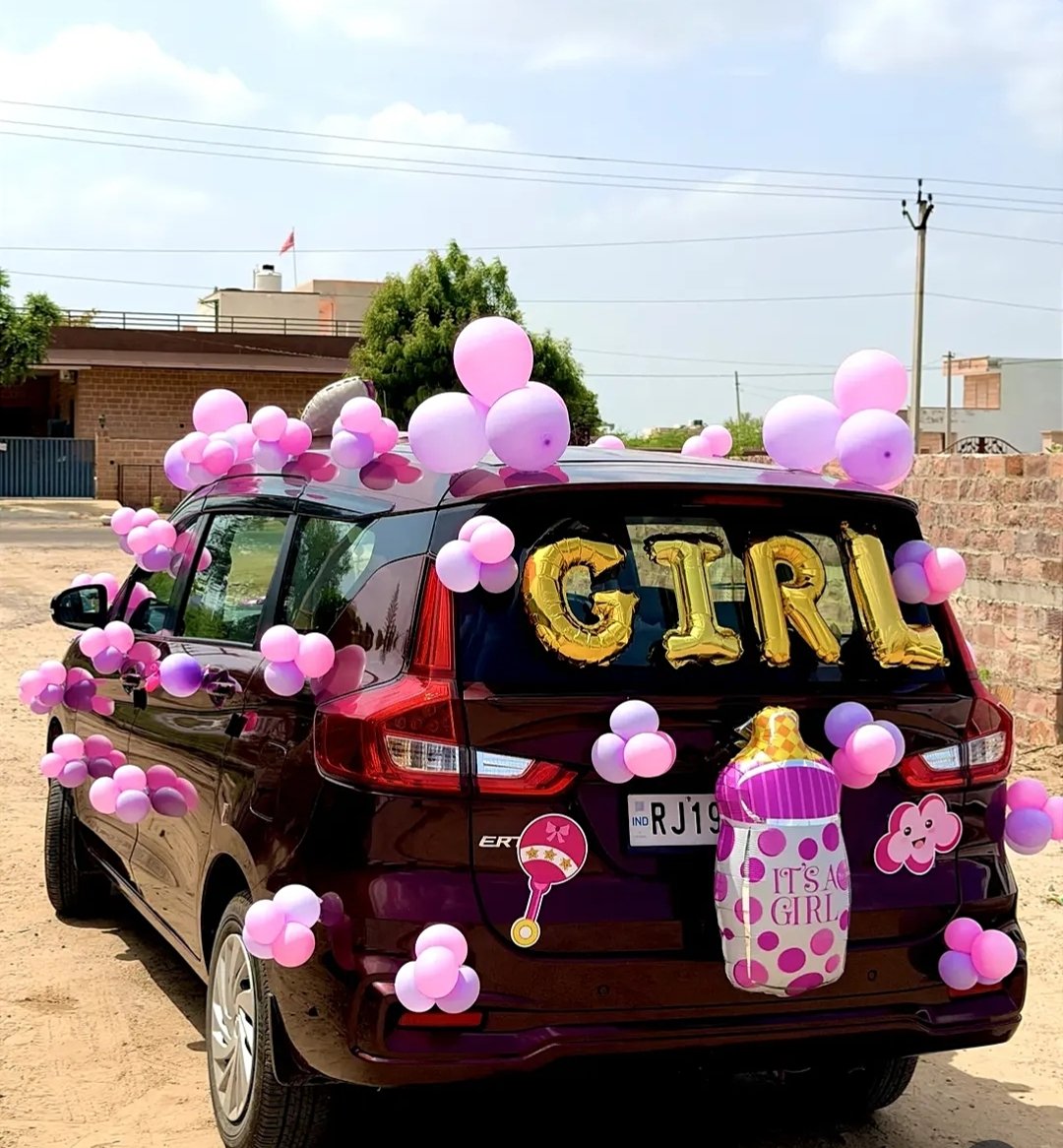 Car decorated with pink balloons for a baby welcome