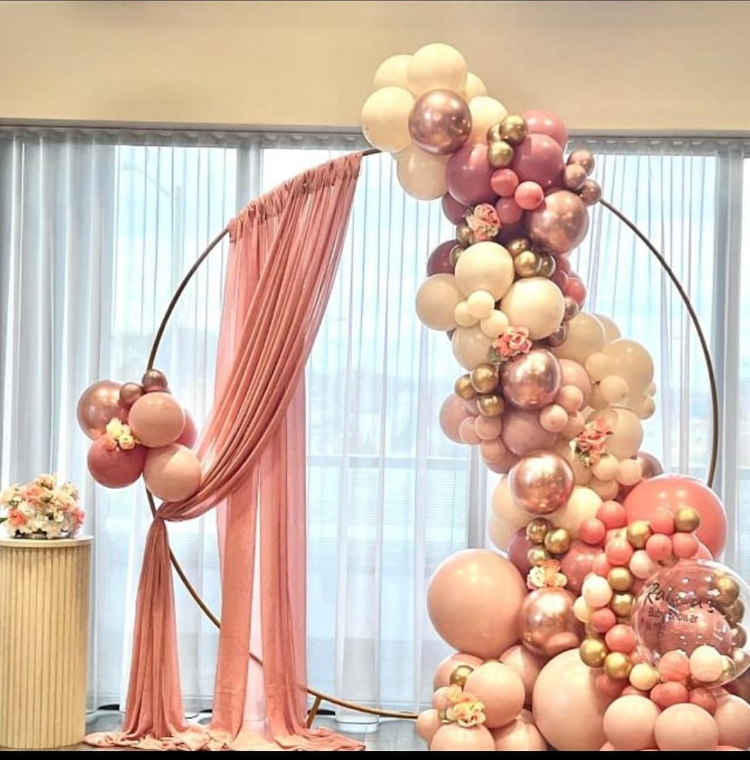Rose gold balloon ring with draped fabric for an anniversary setup
