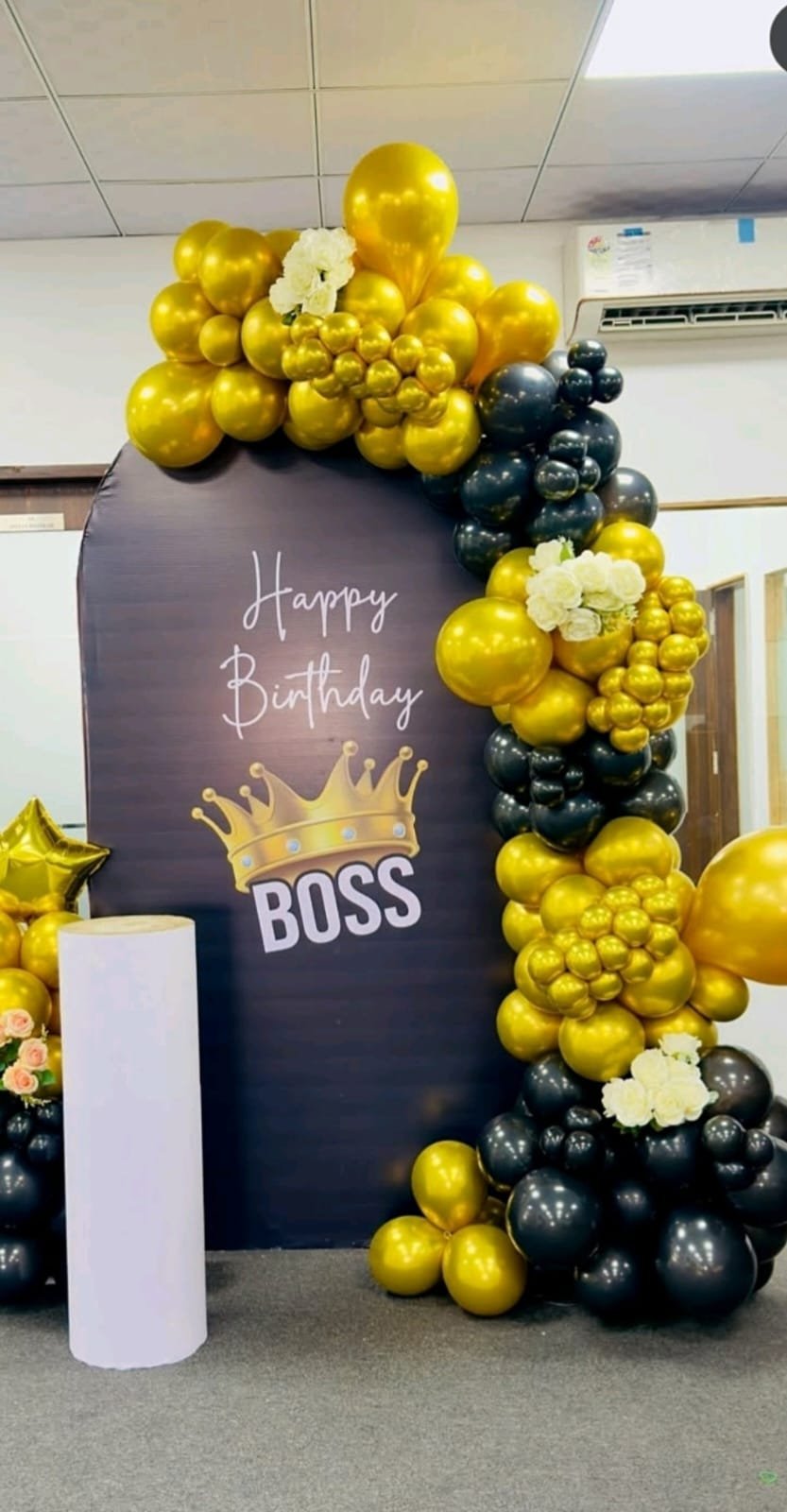 Black and gold corporate birthday decoration in an office